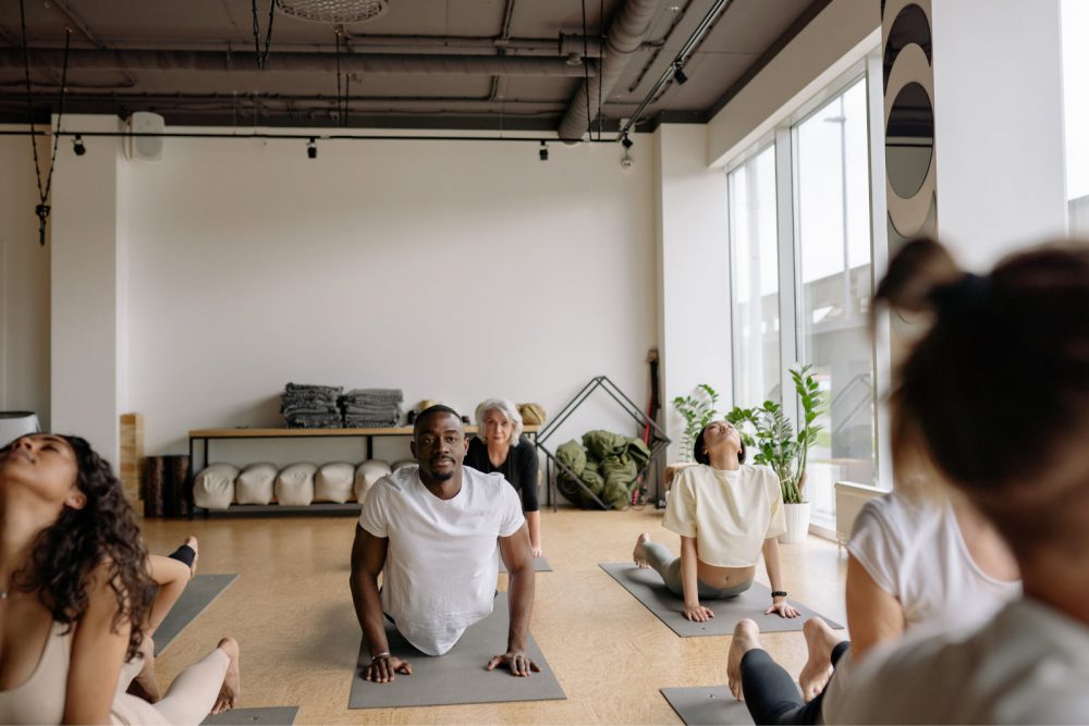 Picture of yoga class with people on yoga mats stretching