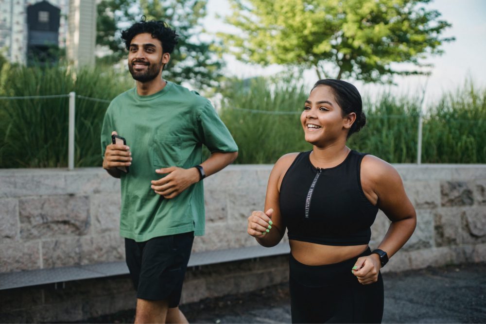 Picture of man and woman running outside